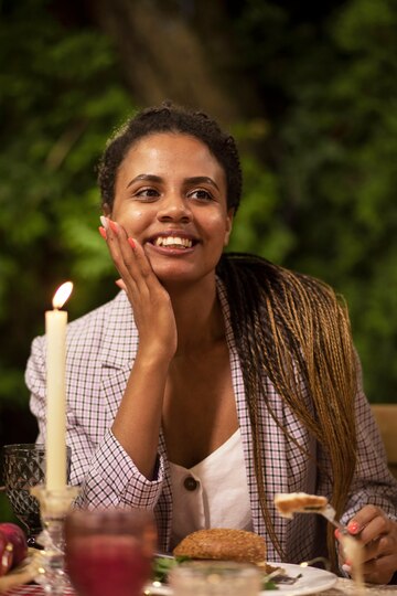 front-view-smiley-woman-sitting-table_23-2149655607